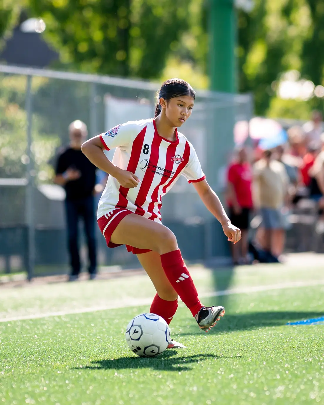 Creative soccer portrait featuring a player, a ball, and flames
