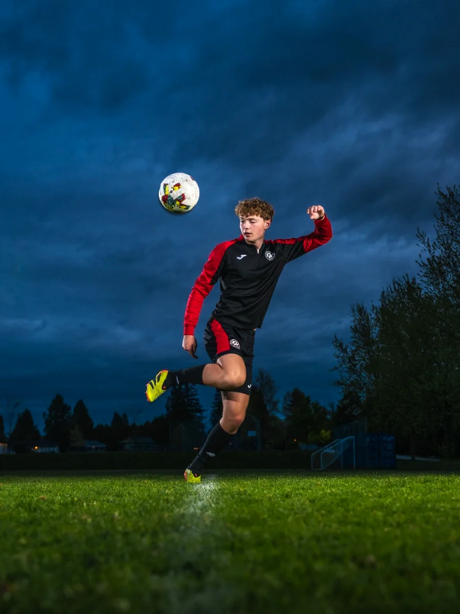 Soccer athlete portrait under dramatic evening lighting
