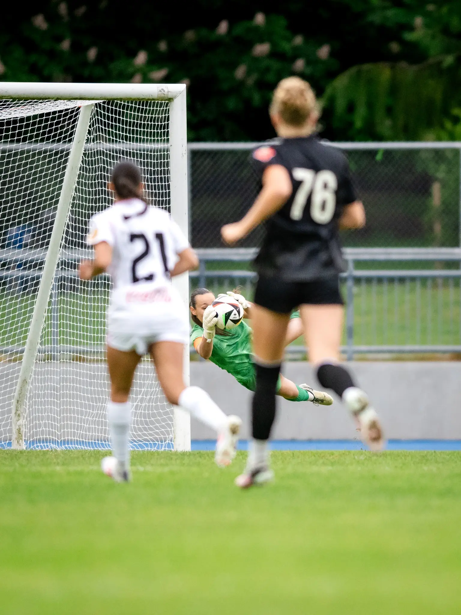 Goalkeeper diving to make a save during a soccer match