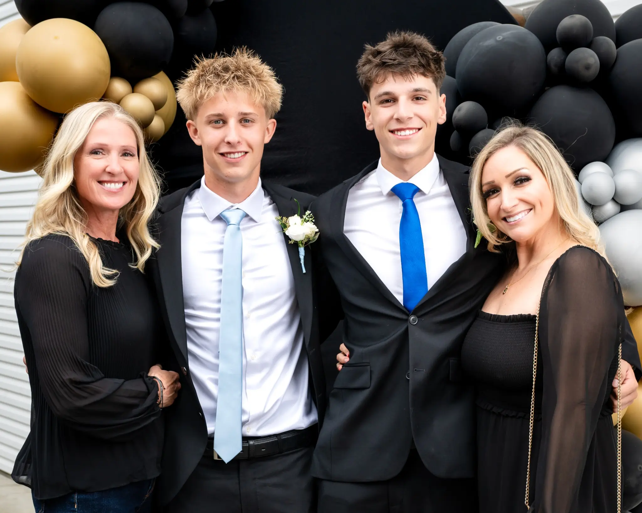 Family posing together in formal attire at a prom celebration