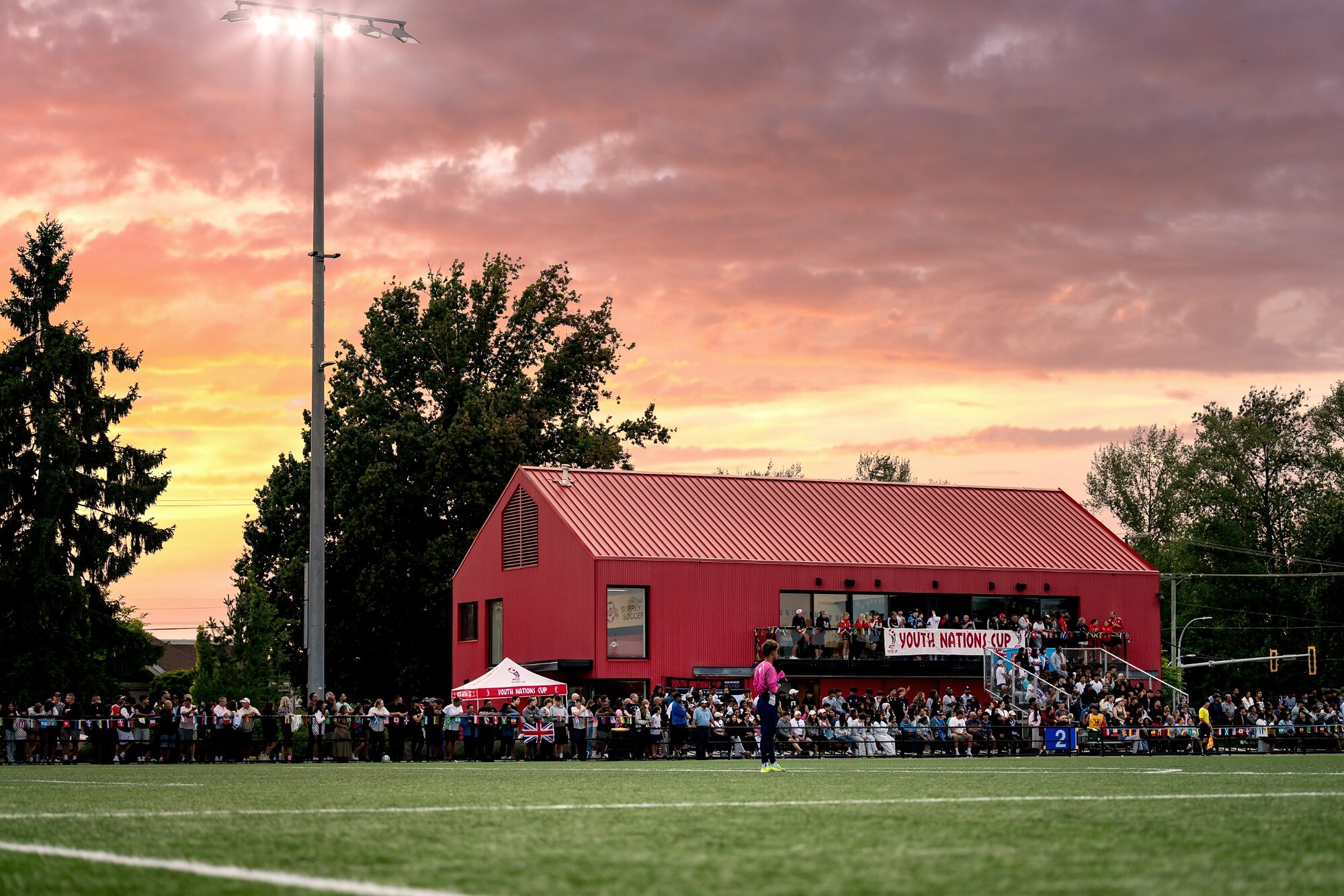 Soccer tournament venue under a colorful sunset
