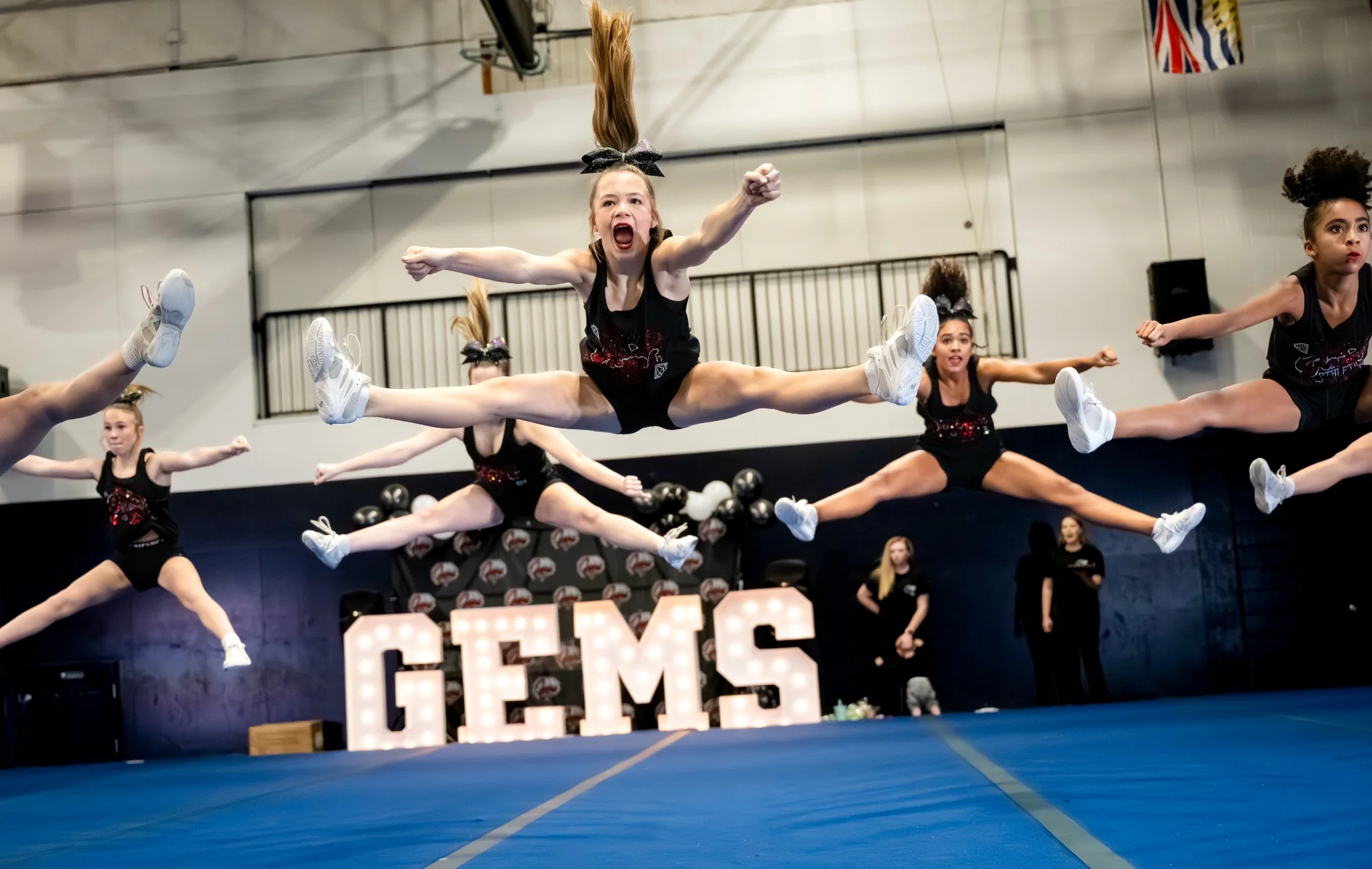 Cheer athletes performing a group jump