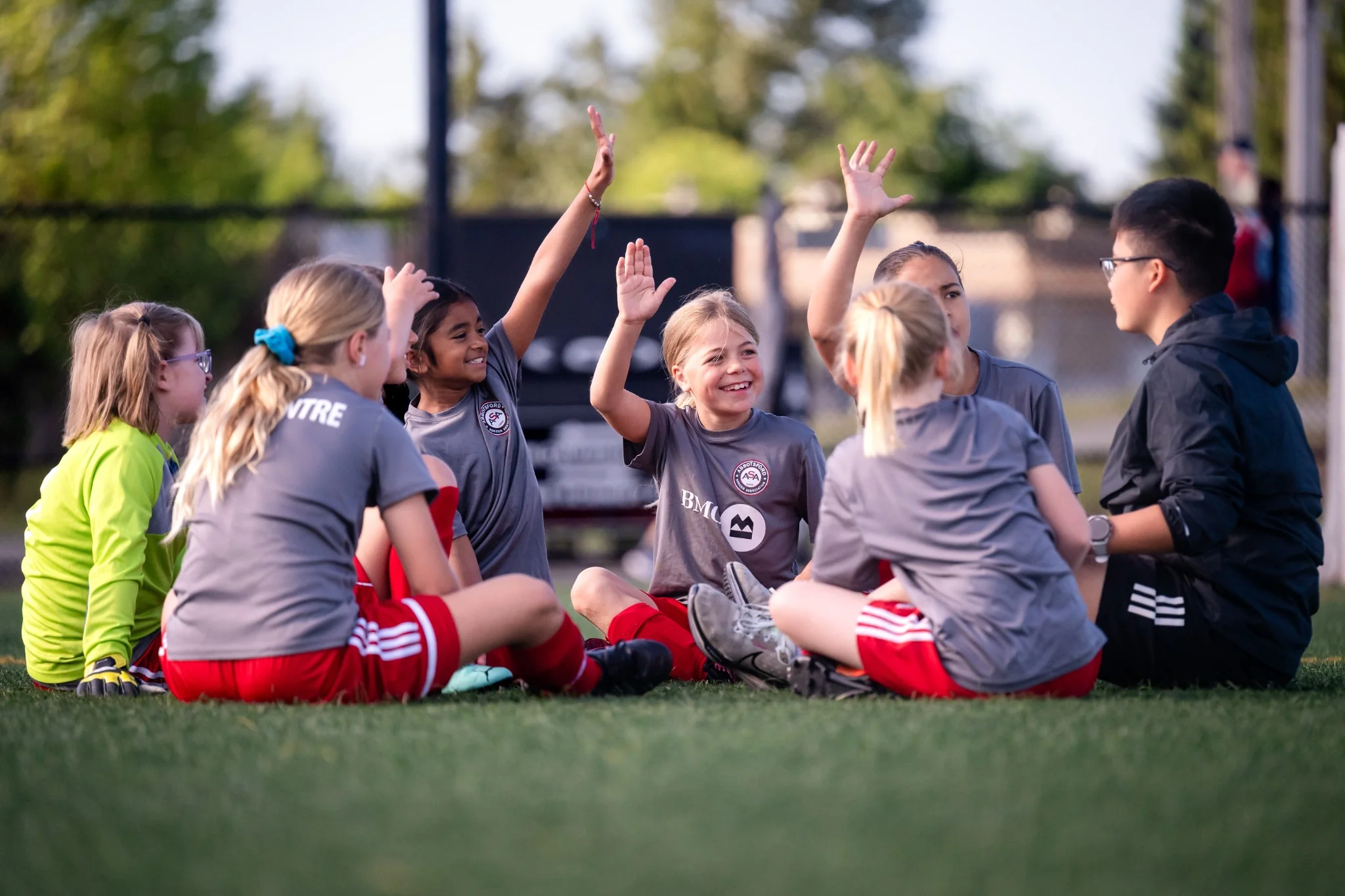 Youth soccer teammates gathered together on the field